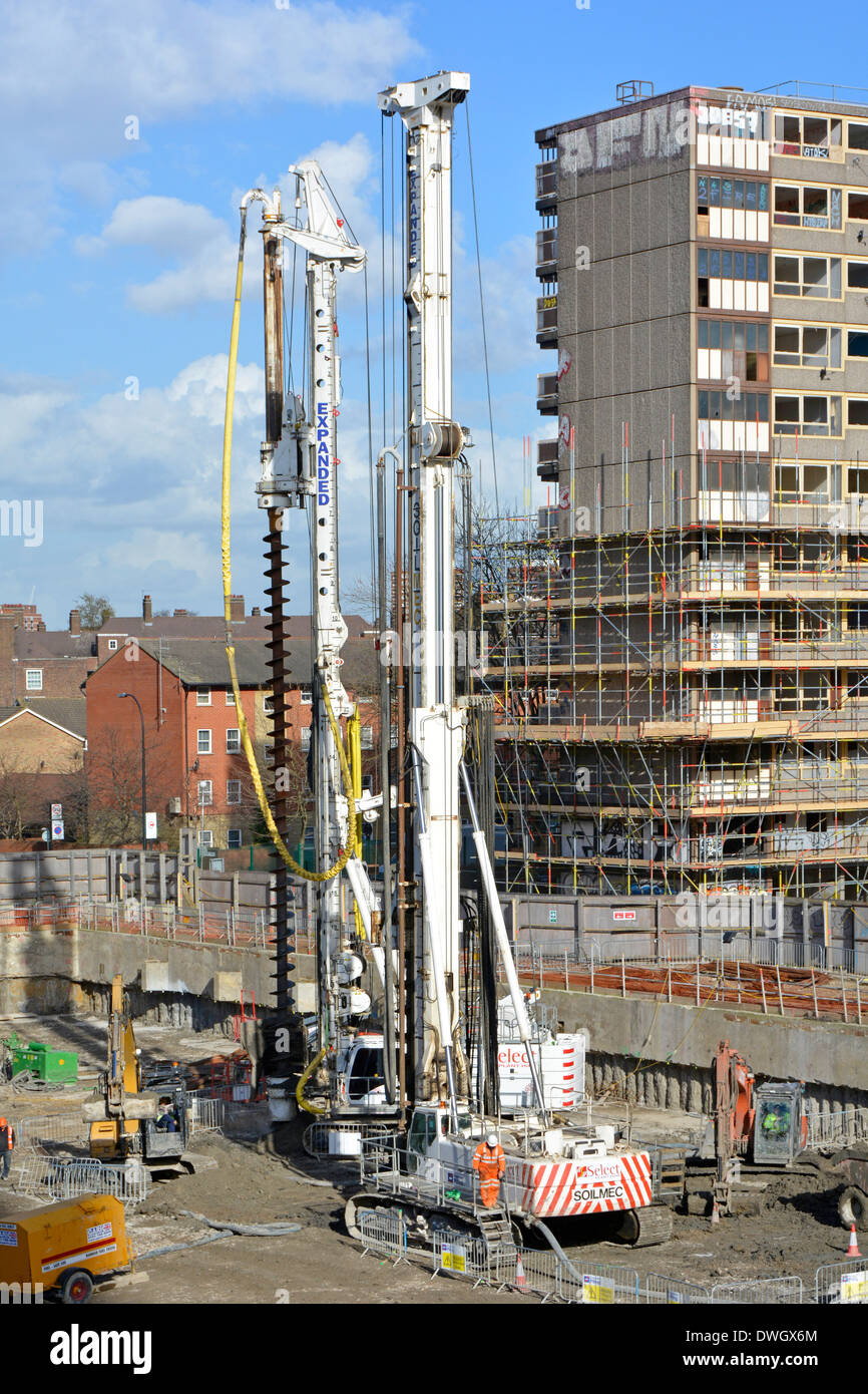 Auger piling rigs on part cleared area of the old social housing Heygate Estate Stock Photo