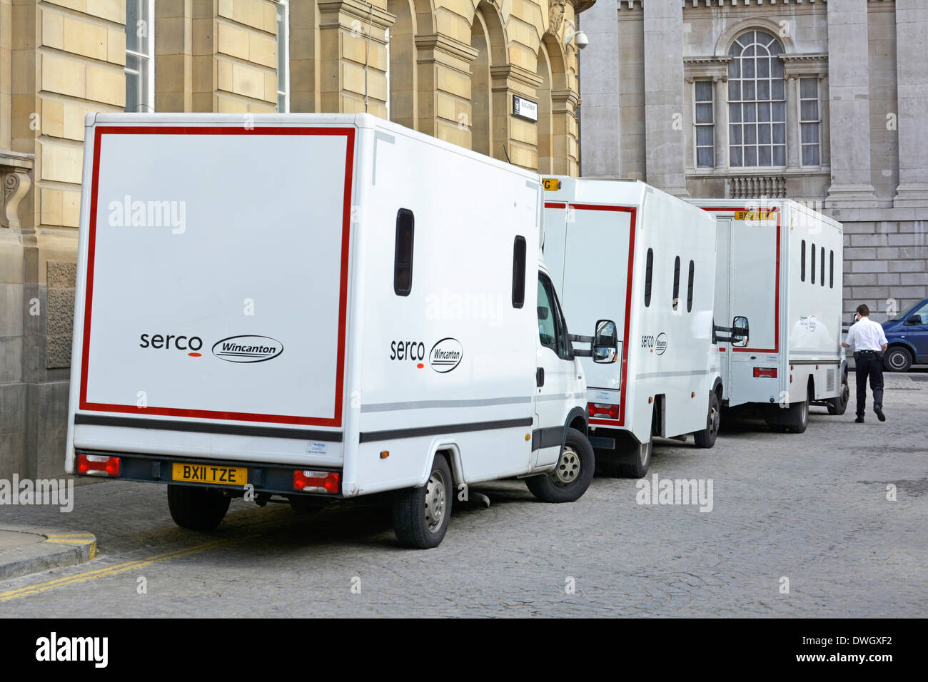 Three joint venture white Serco (outsourcing business) & Wincanton prisoner vans parked outside rear of City of London Magistrates Court England UK Stock Photo