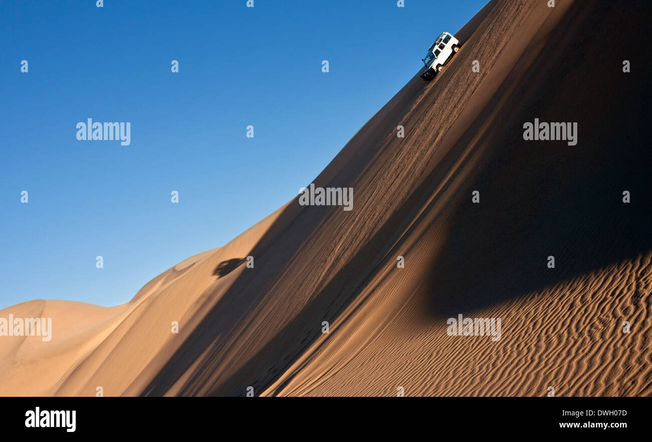 Driving in the sand dunes of the Namib Desert near Sandwich Bay on the coast of Namibia Stock