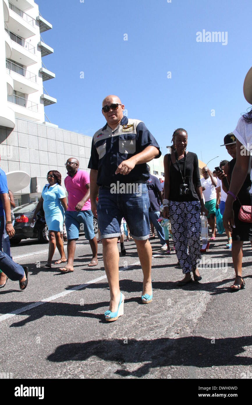 Windhoek, Namibia. 8th March 2014. A man wearing high-heels participates in a march to protest gender based violence in Windhoek. Dozens of men wearing high-heels participated in the 'Men March to Stop Gender Based Violence & Passion Killing in Namibia' in Namibian capital Windhoek on Saturday. The march aims to protest the surge of fatal crimes and violence against Namibian women since the beginning of this year, during which period over ten women were killed by their male partners in the southwestern African country with a population of two millio Credit:  Xinhua/Alamy Live News Stock Photo