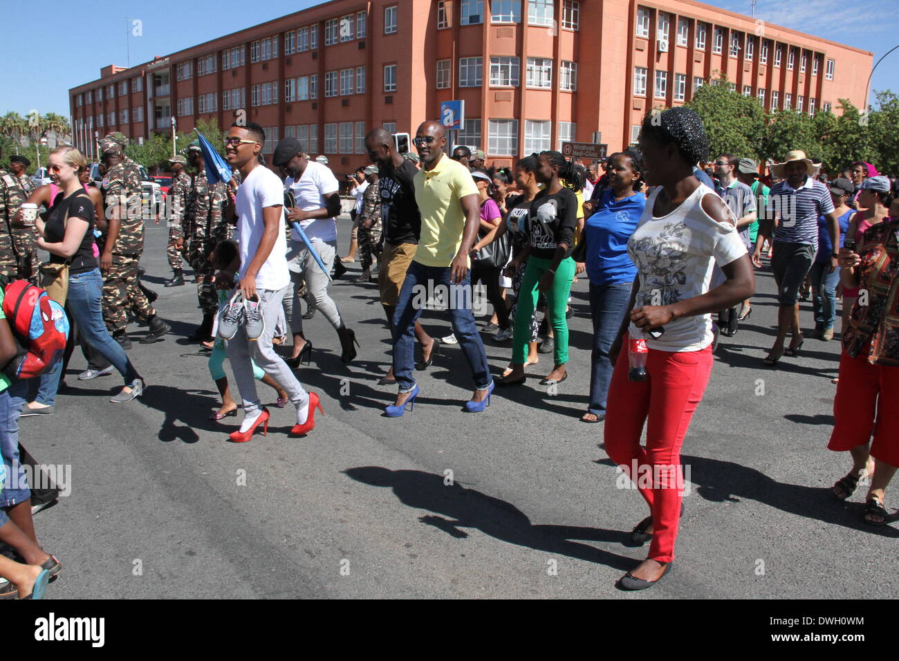 Windhoek, Namibia. 8th March 2014. Men wearing high-heels participate in a march to protest gender based violence in Windhoek. Dozens of men wearing high-heels participated in the 'Men March to Stop Gender Based Violence & Passion Killing in Namibia' in Namibian capital Windhoek on Saturday. The march aims to protest the surge of fatal crimes and violence against Namibian women since the beginning of this year, during which period over ten women were killed by their male partners in the southwestern African country with a population of two million. Credit:  Xinhua/Alamy Live News Stock Photo