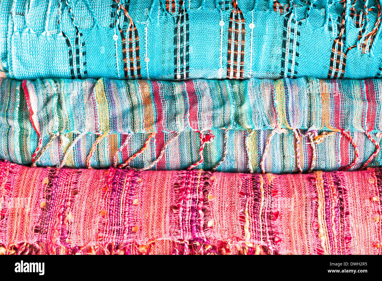 Rolled up colorful ladies scarves as a background Stock Photo