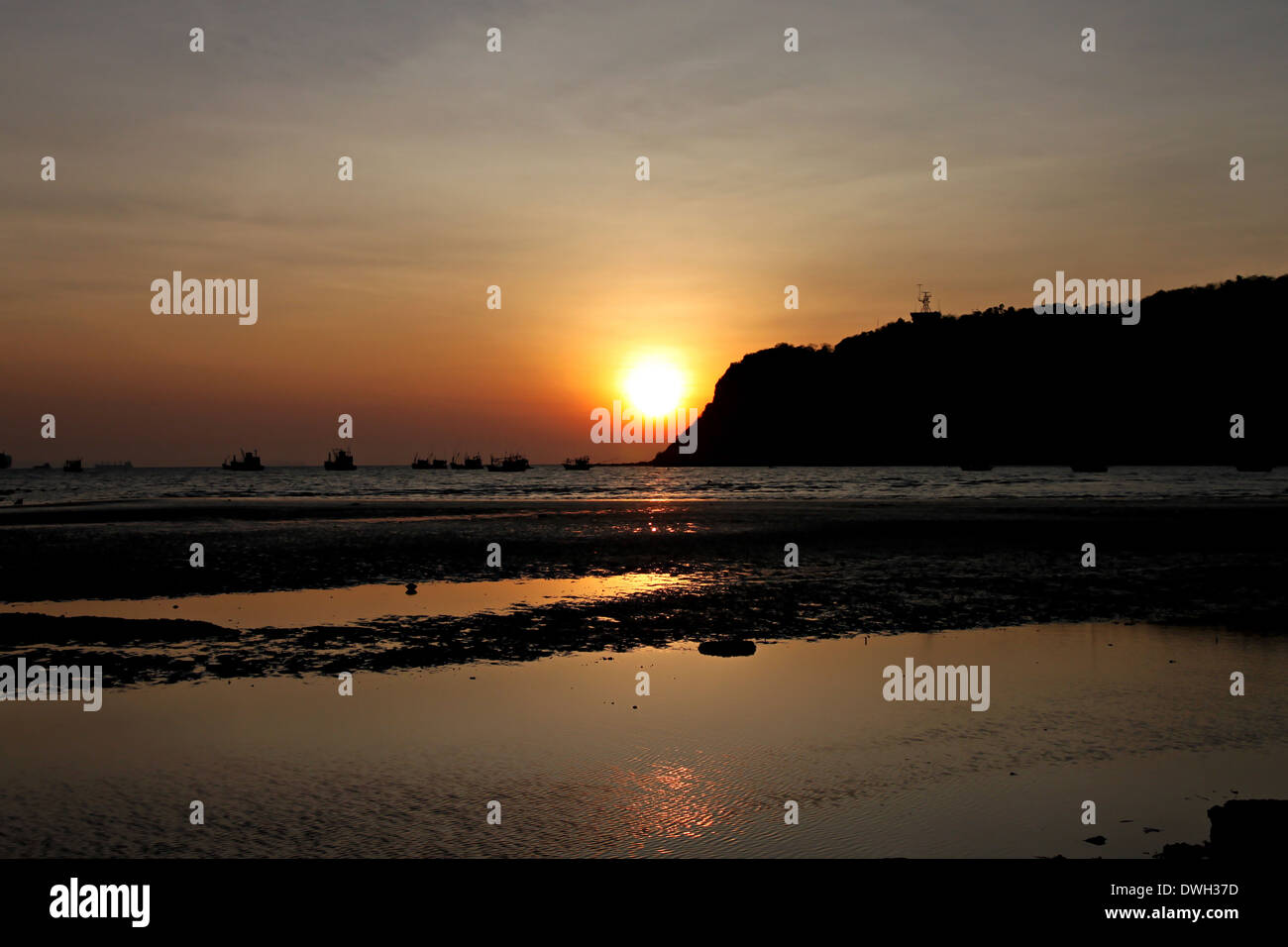 Silhouette Seaside in evening with see the sunset. Stock Photo