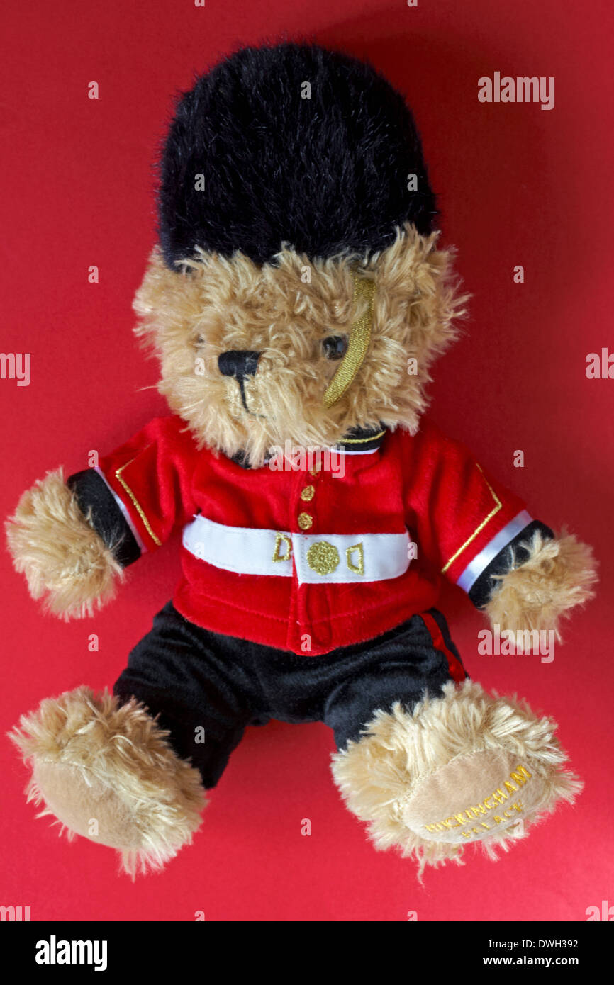 Buckingham Palace beefeater soldier guard Teddy bear isolated on red background Stock Photo
