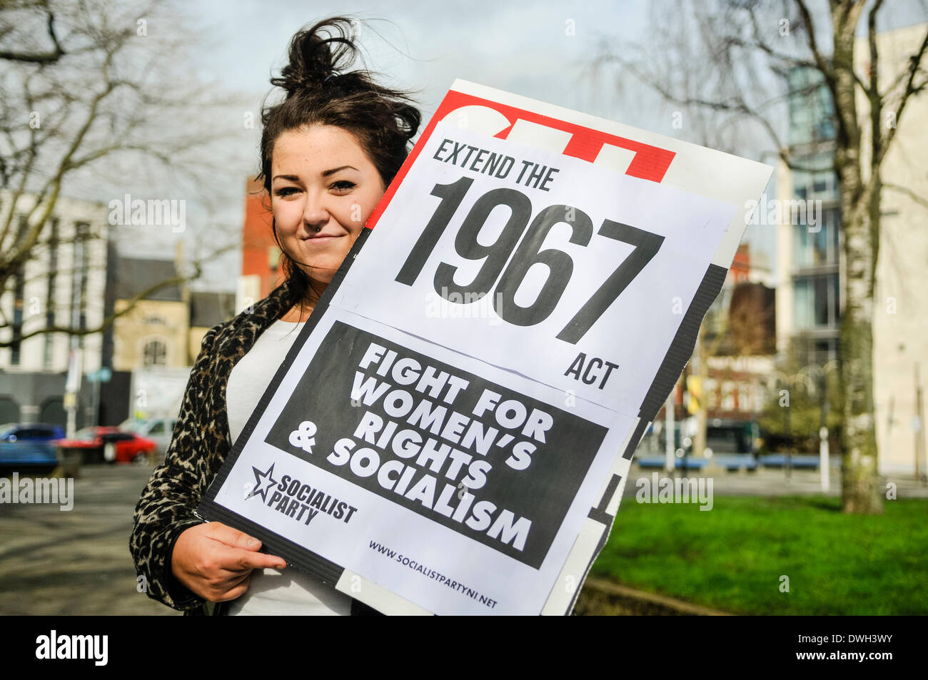 Belfast, Northern Ireland. 8 Mar 2014 - A woman holds a poster saying 'Extend the 1967 [abortion] act [to Northern Ireland]' at the start of the International Women's Day parade Credit:  Stephen Barnes/Alamy Live News Stock Photo