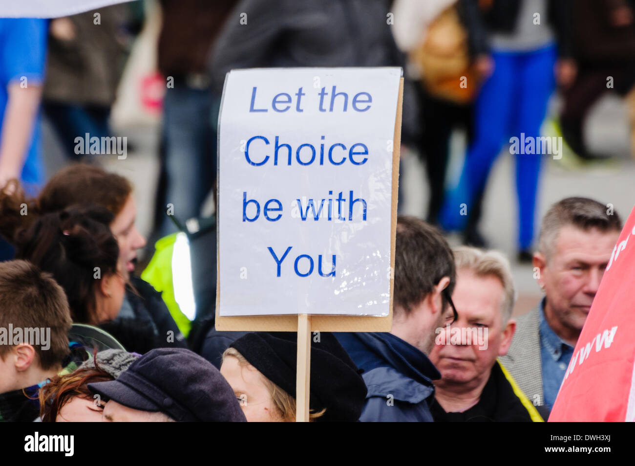 Belfast, Northern Ireland. 8 Mar 2014 - A poster is held up saying 'Let the Choice be with You' from a pro-choice abortion campaigner. Credit:  Stephen Barnes/Alamy Live News Stock Photo