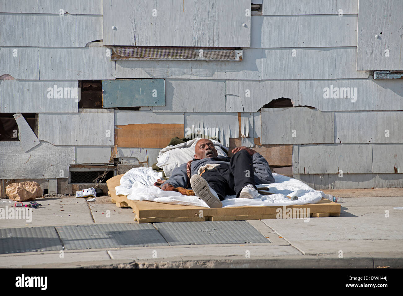Homeless man sleeping on sidewalk, Golden Hill, San Diego, California Stock Photo