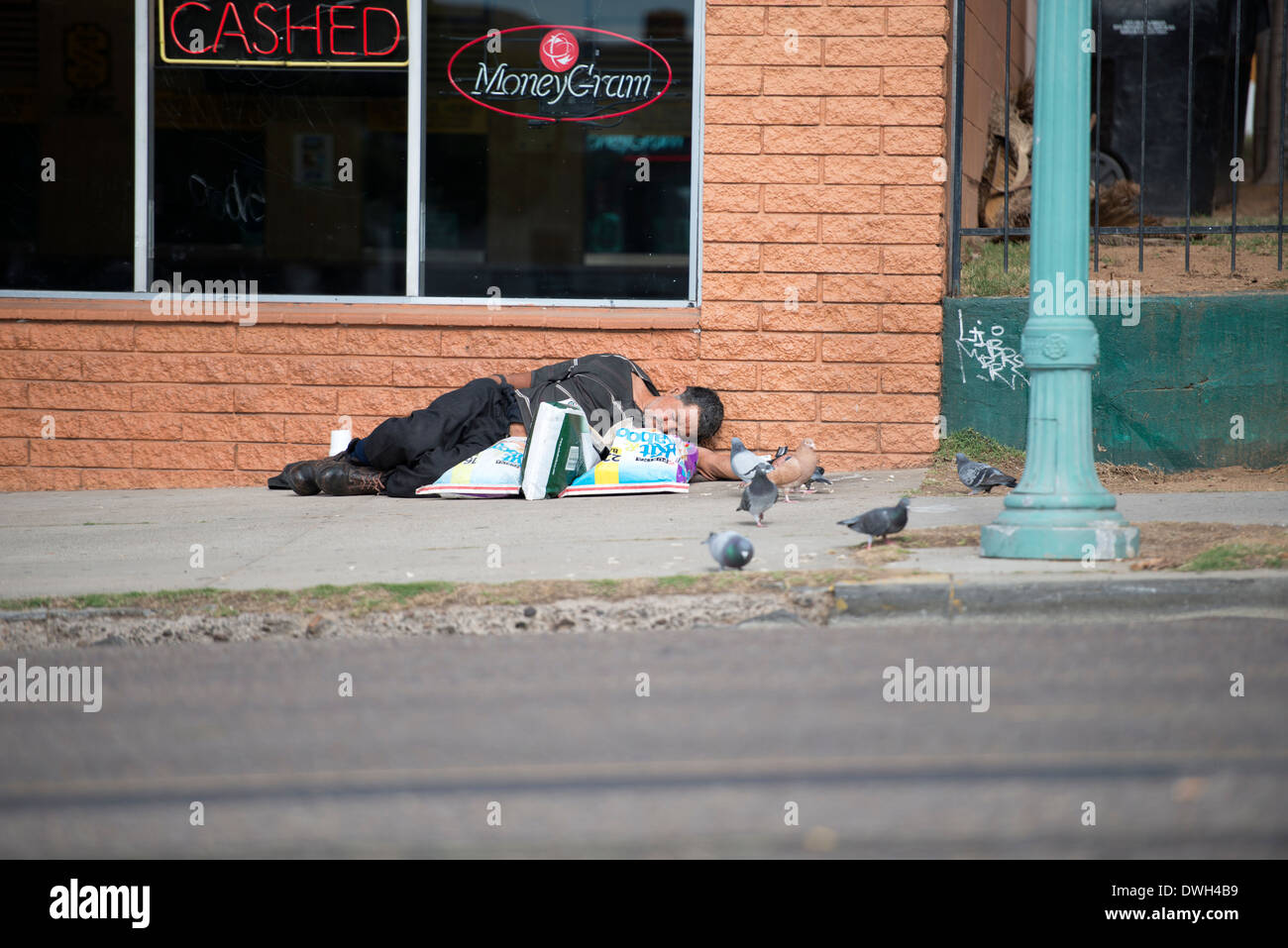 Homeless man sleeping on sidewalk, Golden Hill, San Diego, California Stock Photo
