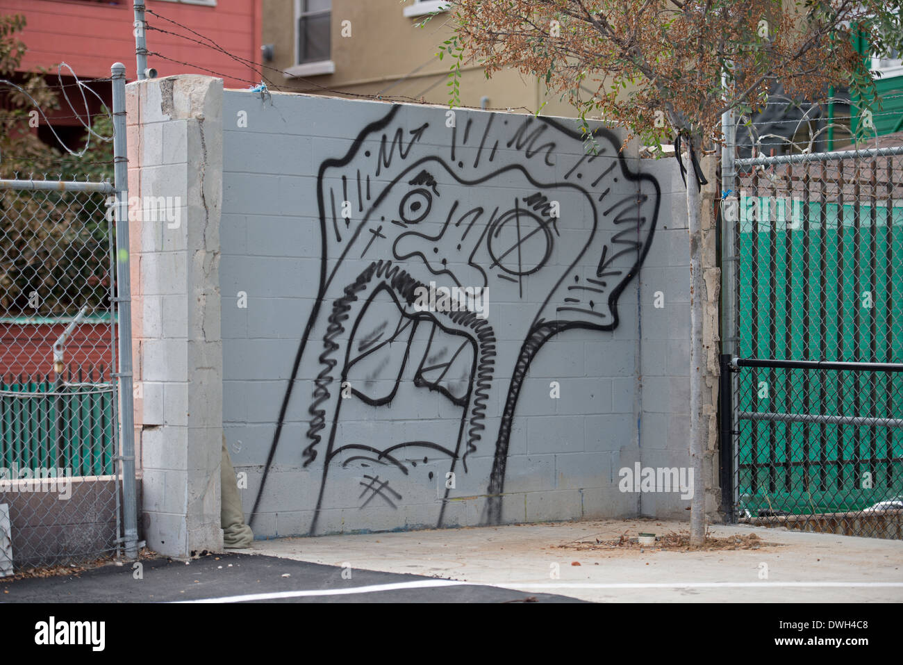 Black Spray Painted Graffiti of Face on Wall, Downtown, San Diego, California USA Stock Photo