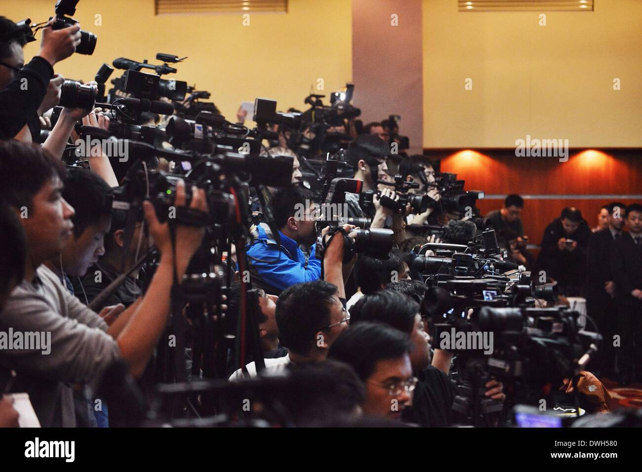 Beijing, China. 9th Mar, 2014. Photographers take photos during the Malaysia Airlines press conference in Beijing on missing flight MH 370 on March 9, 2014. Credit:  Wang Quanchao/Xinhua/Alamy Live News Stock Photo