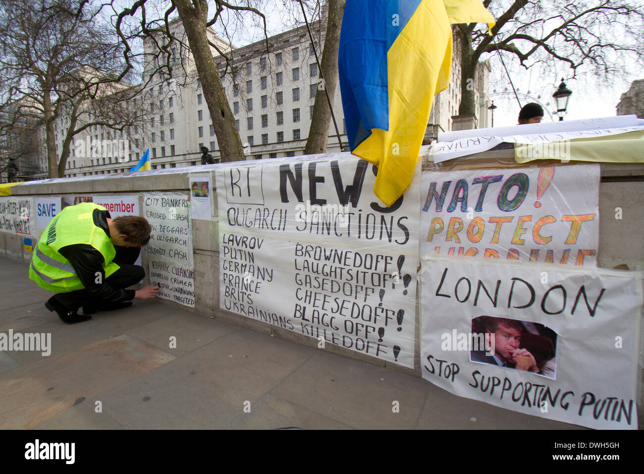 Westminster London ,UK. 8th March 2014. Ukrainian protesters continue to hold a 24hour shift protest outside Downing Street with placards following the Russian military intervention in the Crimea demanding on the British Government to keep its promises on the Budapest memorandum on Security Assurances signed in 1994.The Memorandum included security assurances against threats or use of force against the territorial integrity or political independence of Ukraine and as a result Ukraine gave up its stockpile of Nuclear weapons between 1994 and 1996. Credit:  amer ghazzal/Alamy Live News Stock Photo