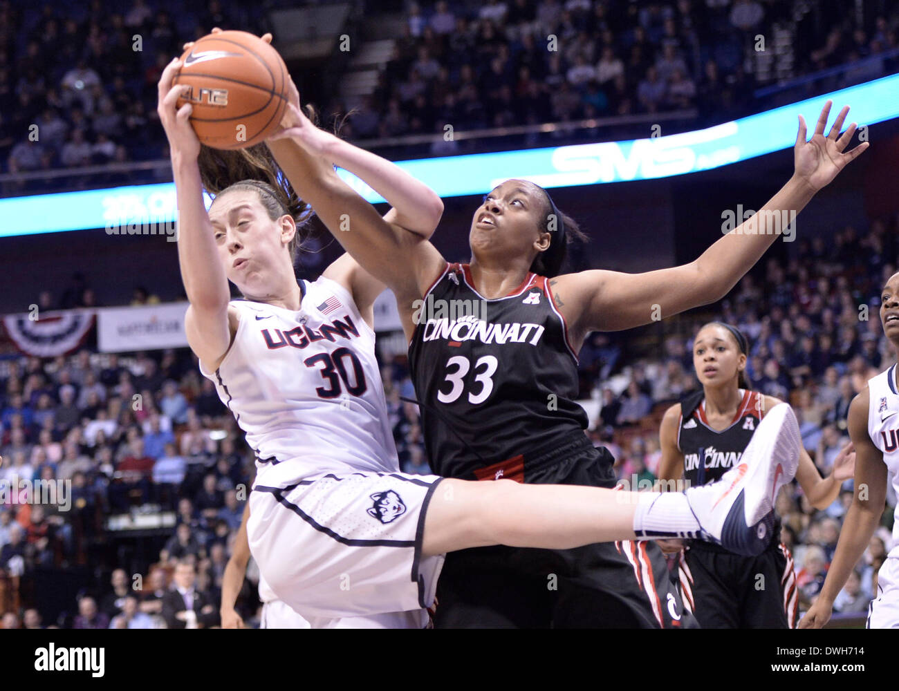 March 8, 2014 - Uncasville, CT, USA - Saturday March 8, 2014: UConn huskies guard-forward Breanna Stewart (30) and Cincinnati Bearcats forward Jeanise Randolph (33) battle for a rebound during the 1st half of the American Athletic Conference womens basketball tournament game between Cincinnati and UConn at Mohegan Sun Arena in Uncasville, CT. Bill Shettle / Cal Sport Media. Stock Photo