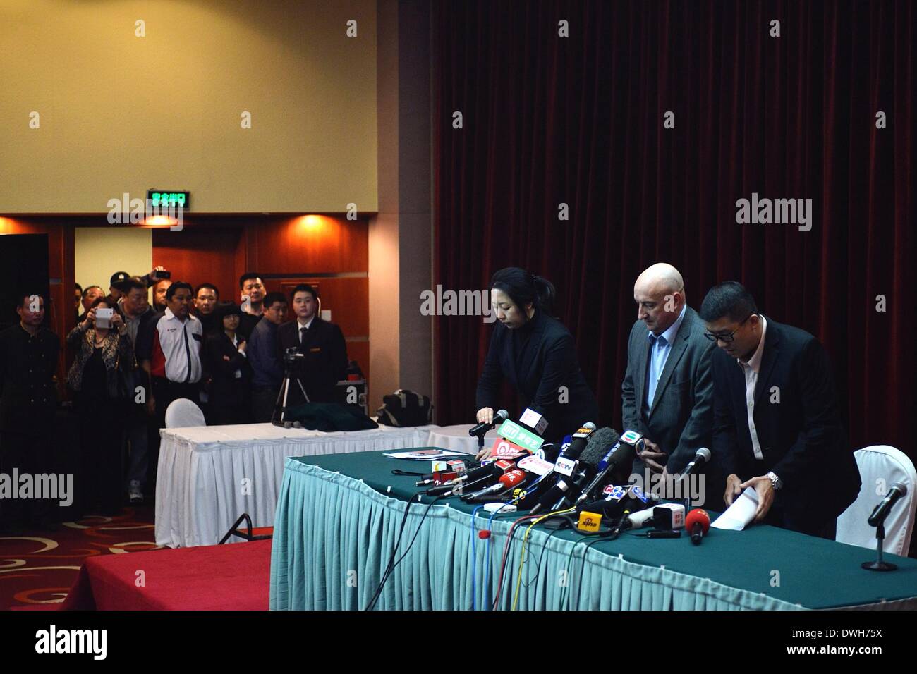 Beijing, China. 9th Mar, 2014. Representatives of the Malaysia Airlines bow to the media before the press conference in Beijing on missing flight MH 370 on March 9, 2014. Credit:  Wang Quanchao/Xinhua/Alamy Live News Stock Photo