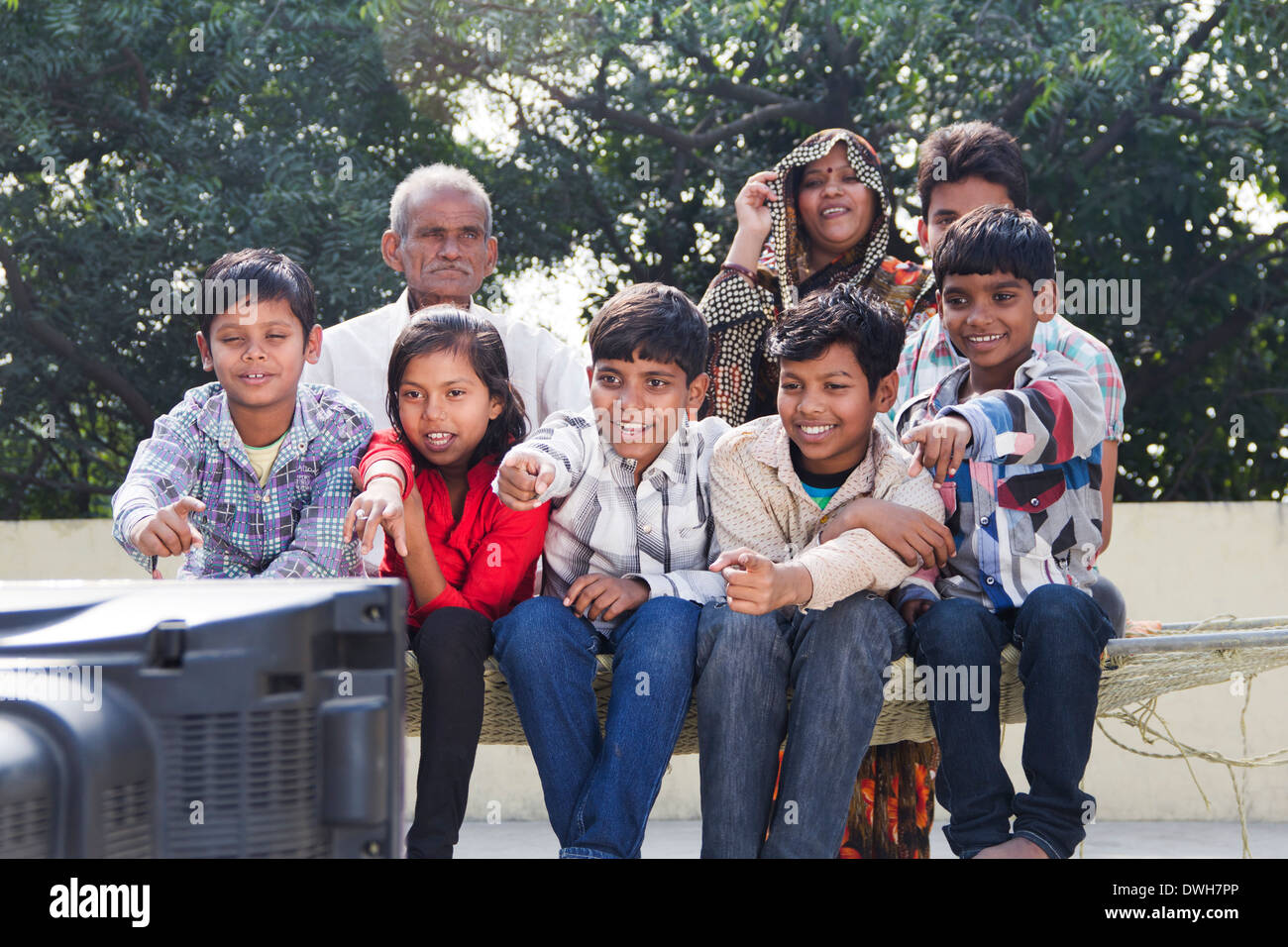 Indian Joint Family sitting and watching Television Stock Photo