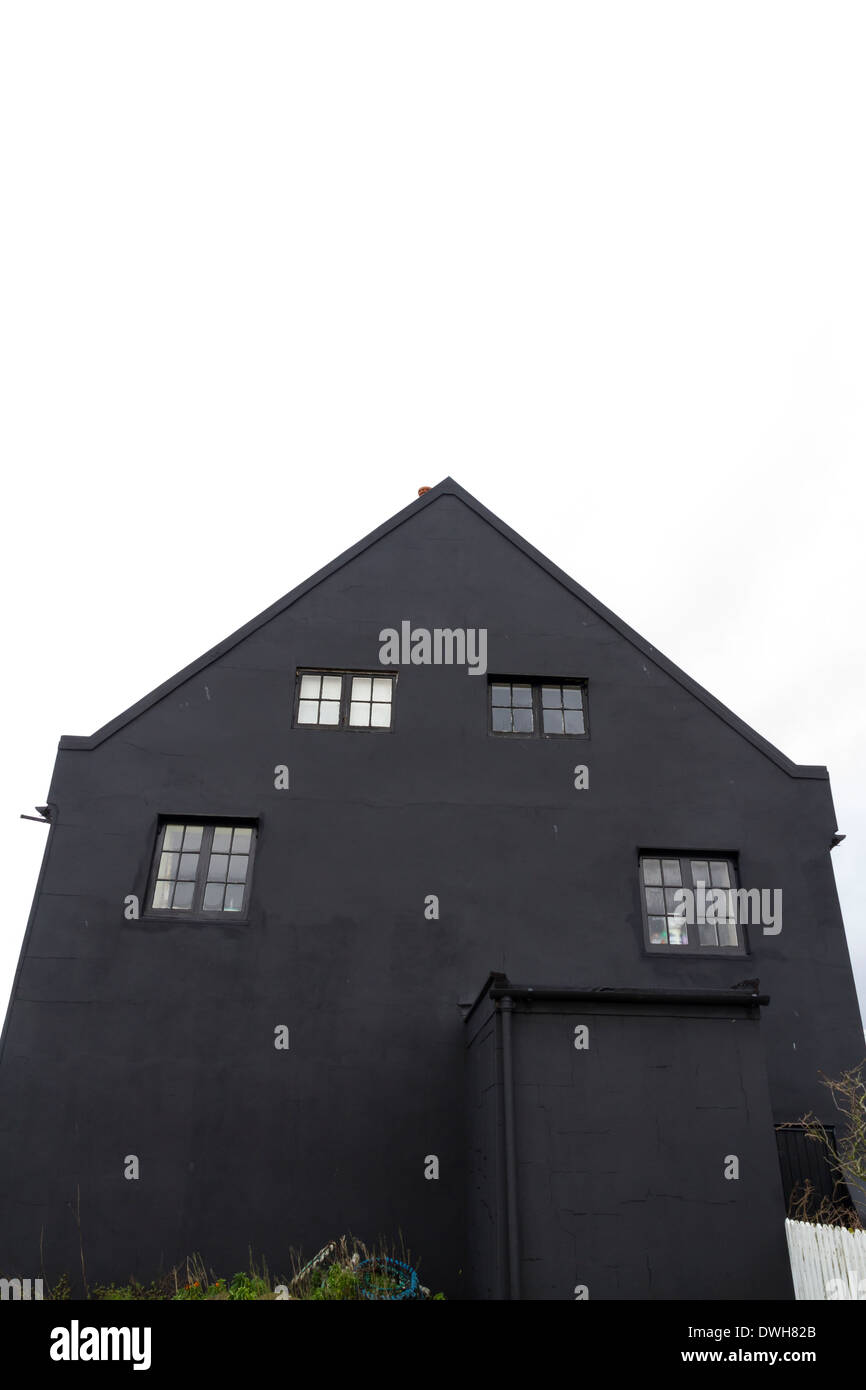 Looking up at the gable end of a black house, white space at top of image. Stock Photo