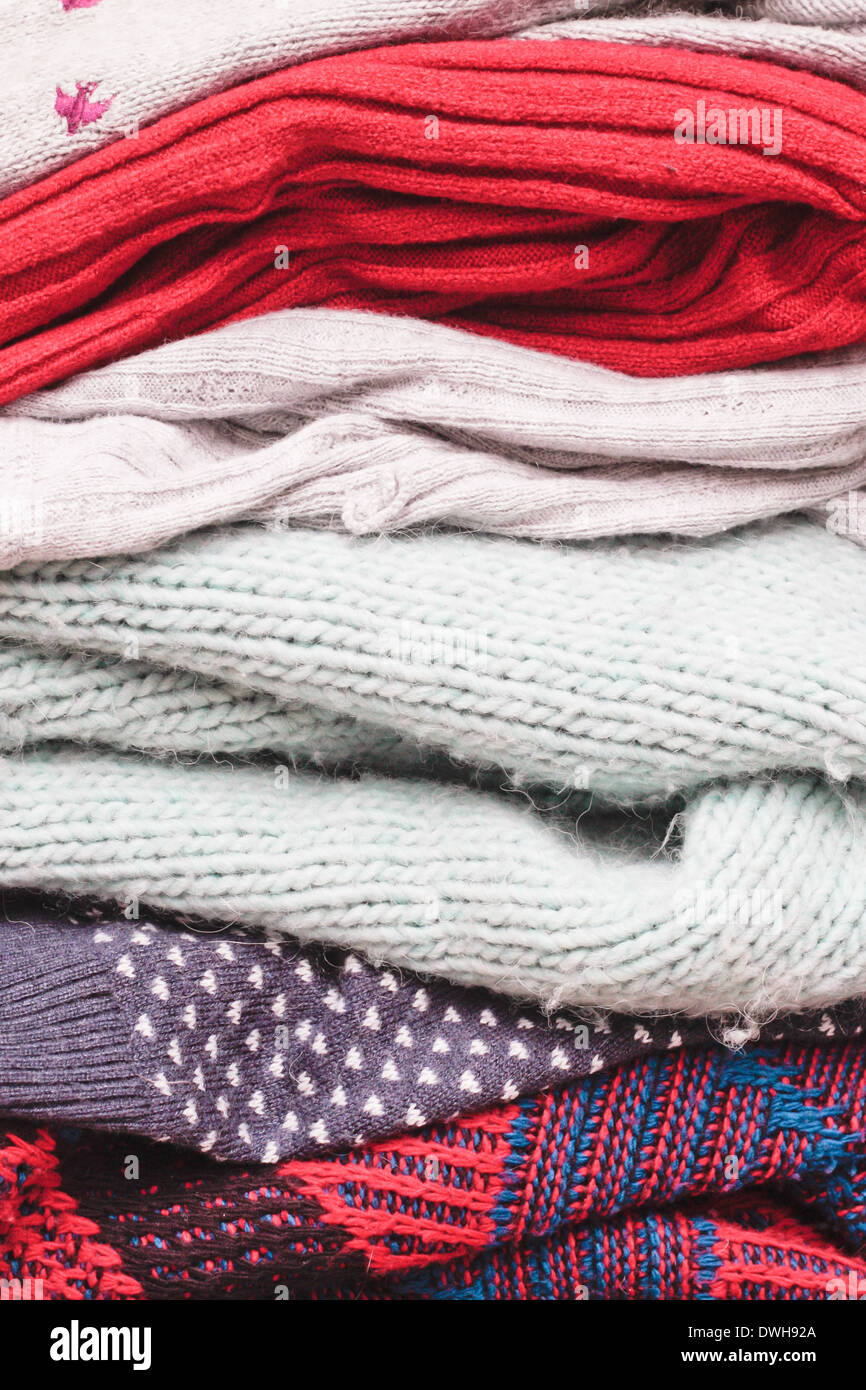 Stacks of folded wool jumpers as a background Stock Photo