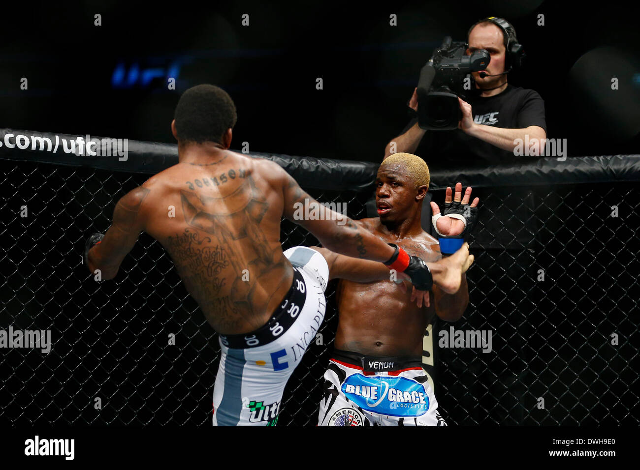 London, UK. 08th Mar, 2014. Michael Johnson (white shorts) fights and beats Melvin Guillard (white and red logo shorts) in a 3 round Lightweight bout on the Main Card at UFC Fight Night London from the O2 Arena. Credit:  Action Plus Sports/Alamy Live News Stock Photo