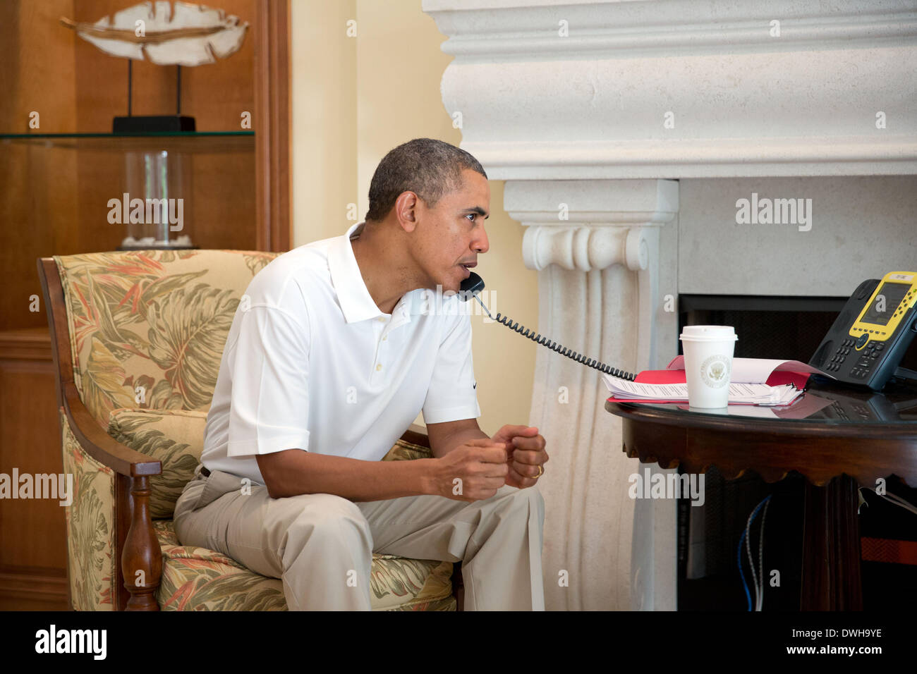 US President Barack Obama talks on the telephone with President Francois Hollande of France discussing the situation in Ukraine March 8, 2014 in Key Largo, Florida. Stock Photo