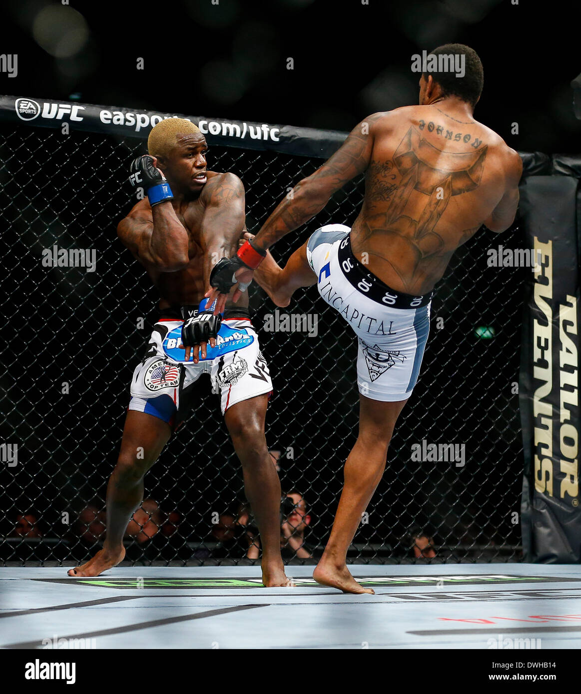 London, UK. 08th Mar, 2014. Michael Johnson (white shorts) fights and beats Melvin Guillard (wjite and red logo shorts) in a 3 round Lightweight bout on the Main Card at UFC Fight Night London from the O2 Arena. Credit:  Action Plus Sports/Alamy Live News Stock Photo