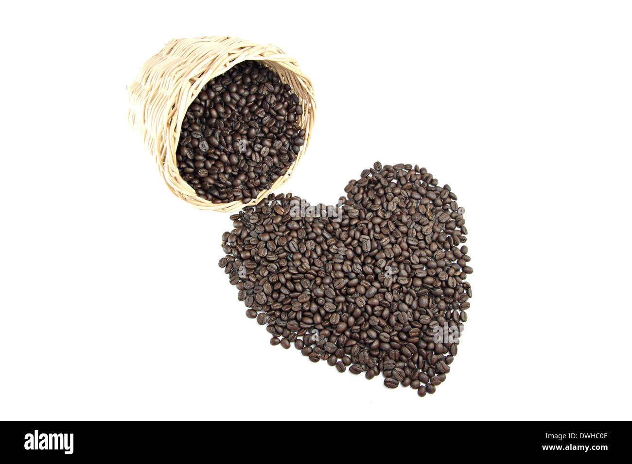 Roasted coffee beans that is shaped like heart on white background. Stock Photo