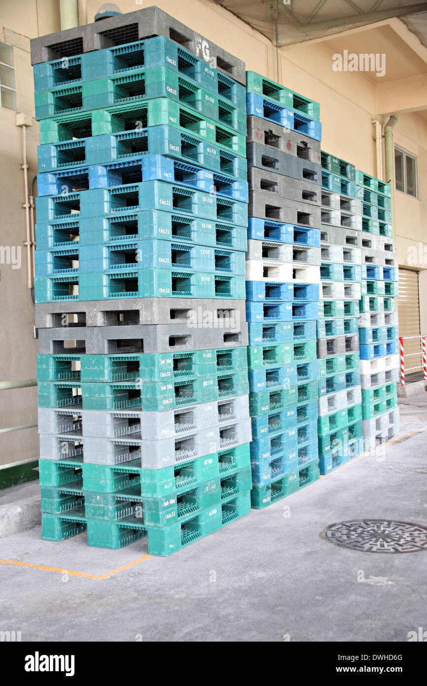 Plastic pallets are stacked can cause accidents in factory. Stock Photo