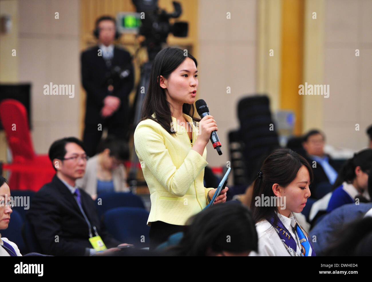 Beijing, China. 9th Mar, 2014. A journalist asks questions at a press conference for the second session of China's 12th National People's Congress (NPC) on legislative and oversight work, in Beijing, capital of China, March 9, 2014. Credit:  Xiao Yijiu/Xinhua/Alamy Live News Stock Photo