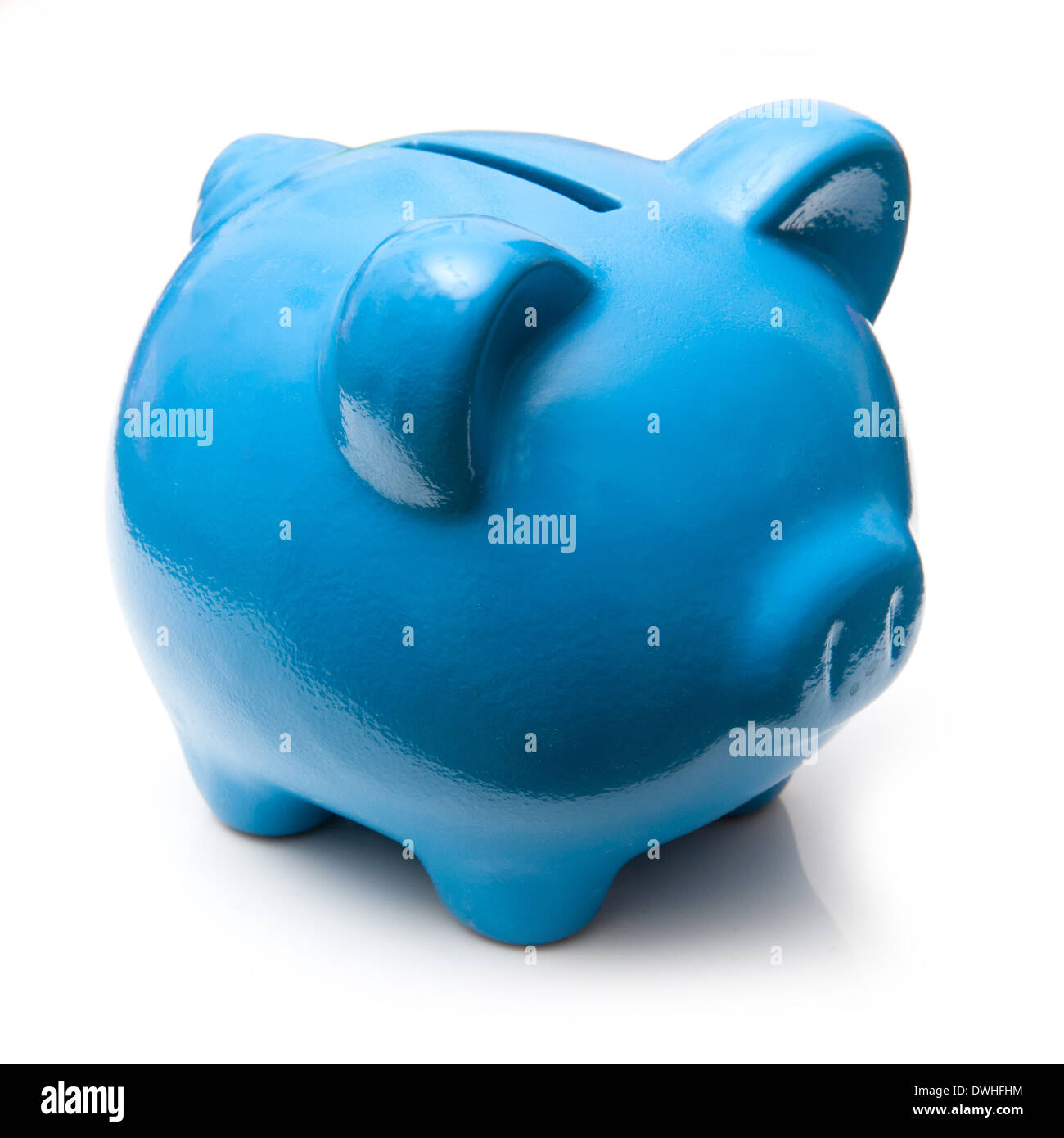 Blue piggy bank style money box isolated on a white studio background ...