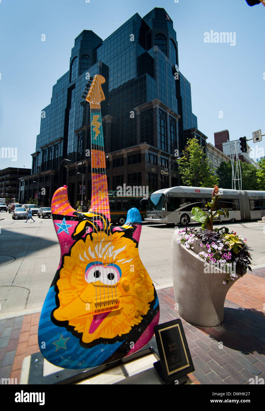 An RTA bus travels down Euclid Avenue in Cleveland OH behind guitar art depicting Big Bird Stock Photo