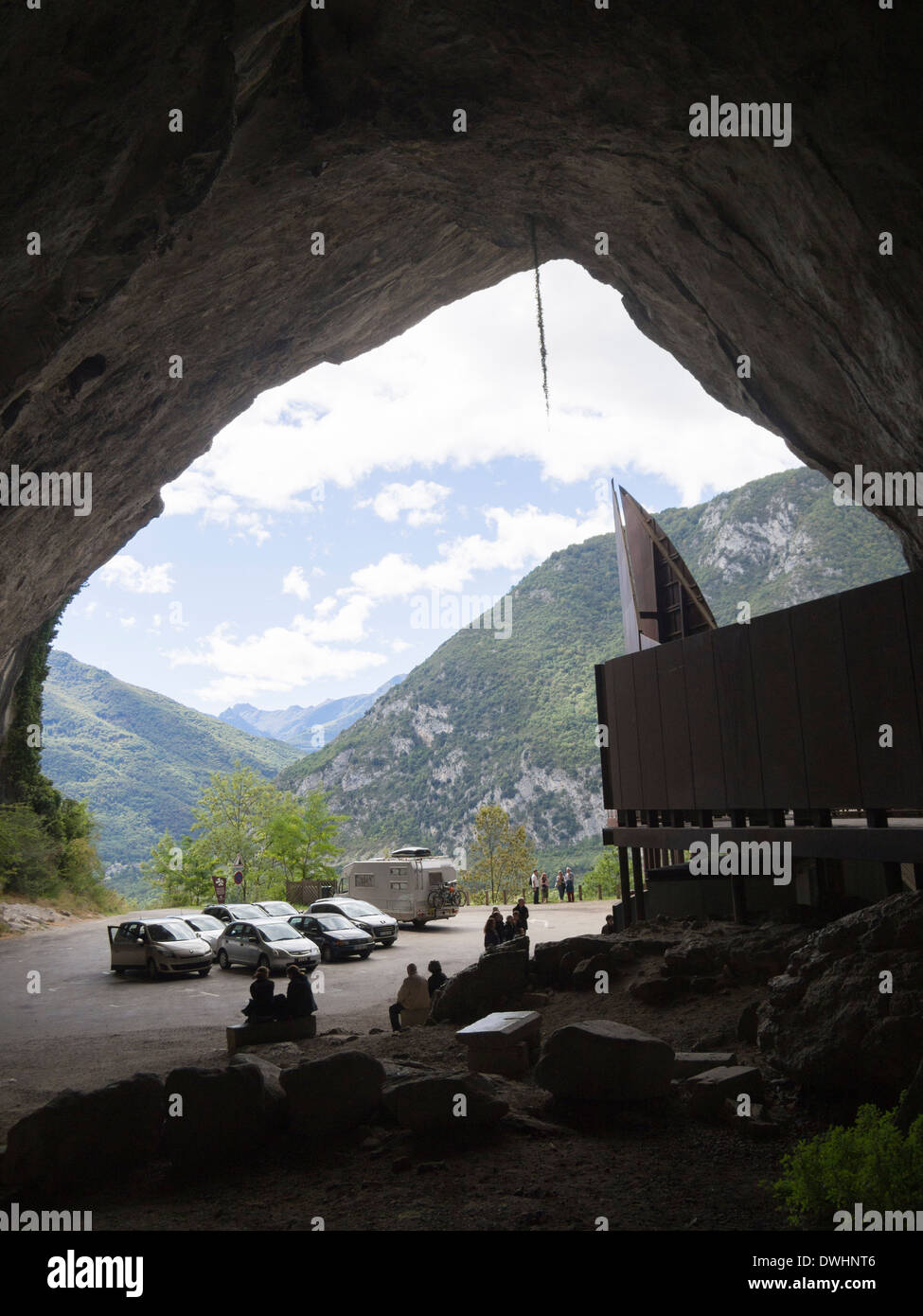 Mouth of the Cave at Niaux, Ariege, France with parked cars of visitors to see the cave paintings Stock Photo