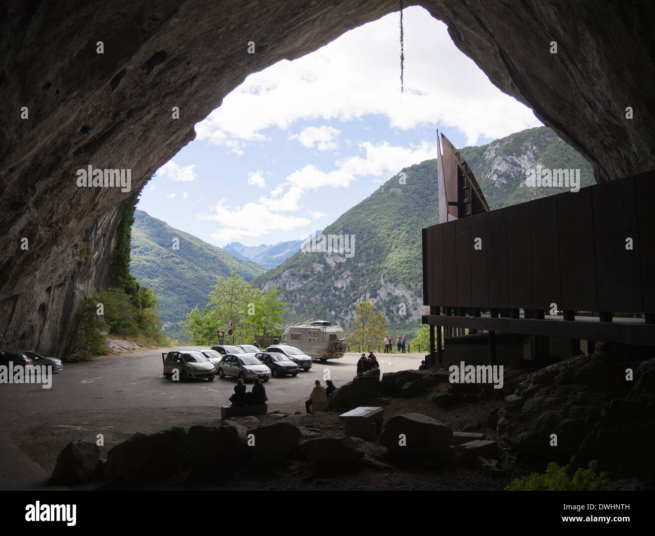 Mouth of the Cave at Niaux, Ariege, France with parked cars of visitors to see the cave paintings Stock Photo