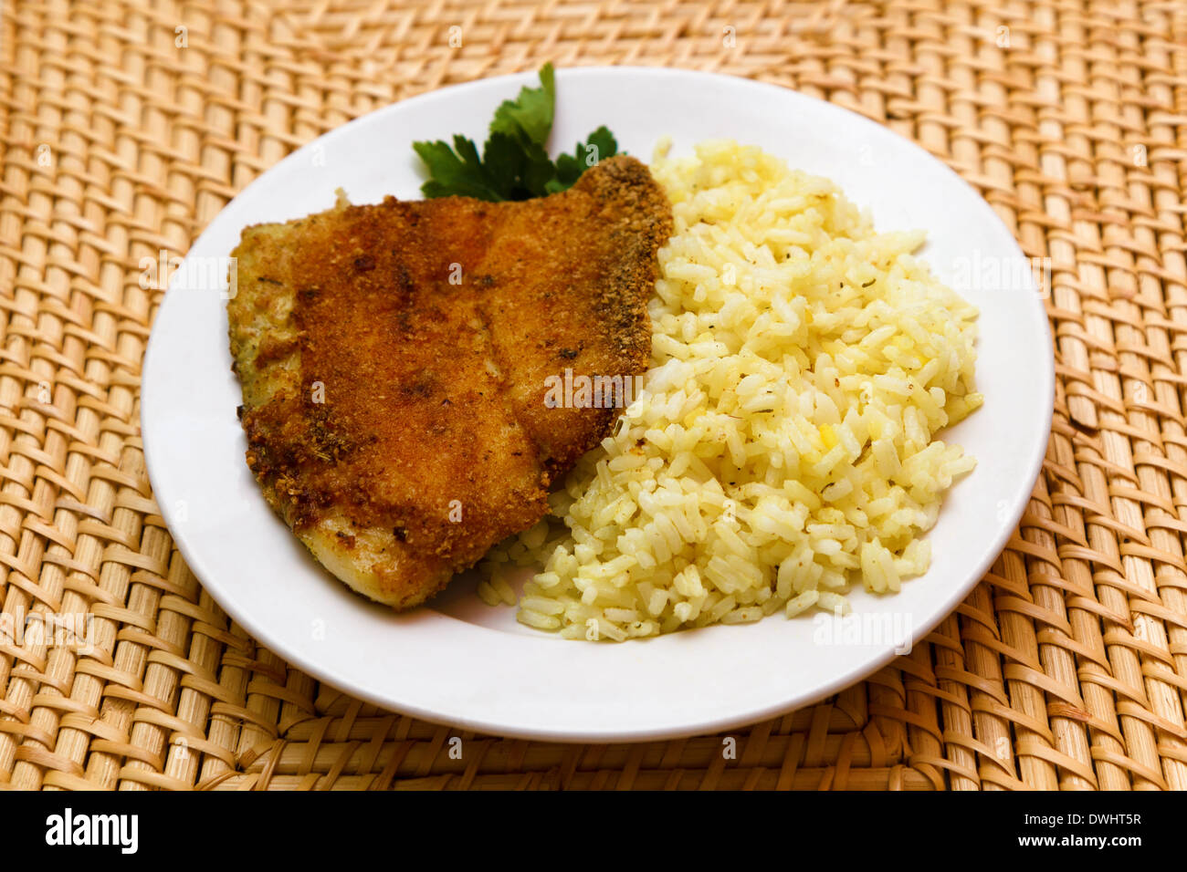 fried breaded tilapia served with rice and herbs Stock Photo Alamy