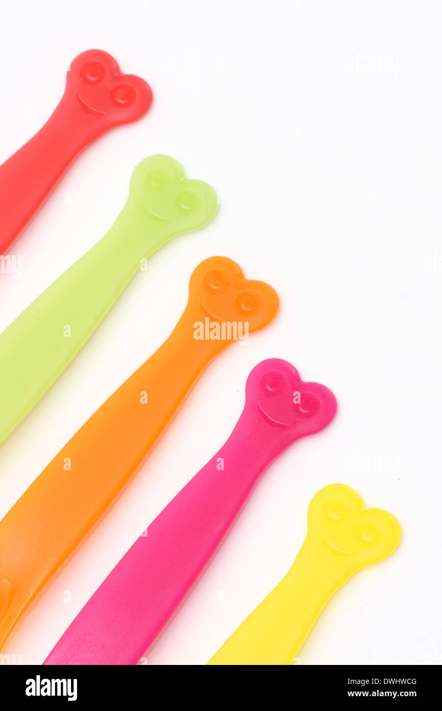 Plastic cutlery handles in a line Stock Photo