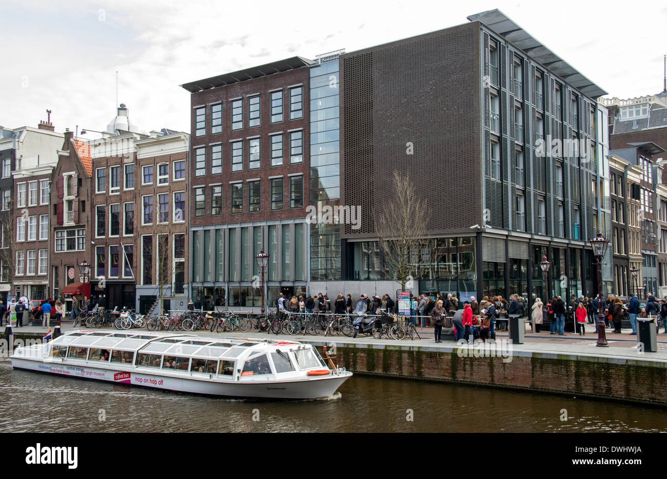 Exterior of Anne Frank House museum in Amsterdam with tourists and canal boat Stock Photo