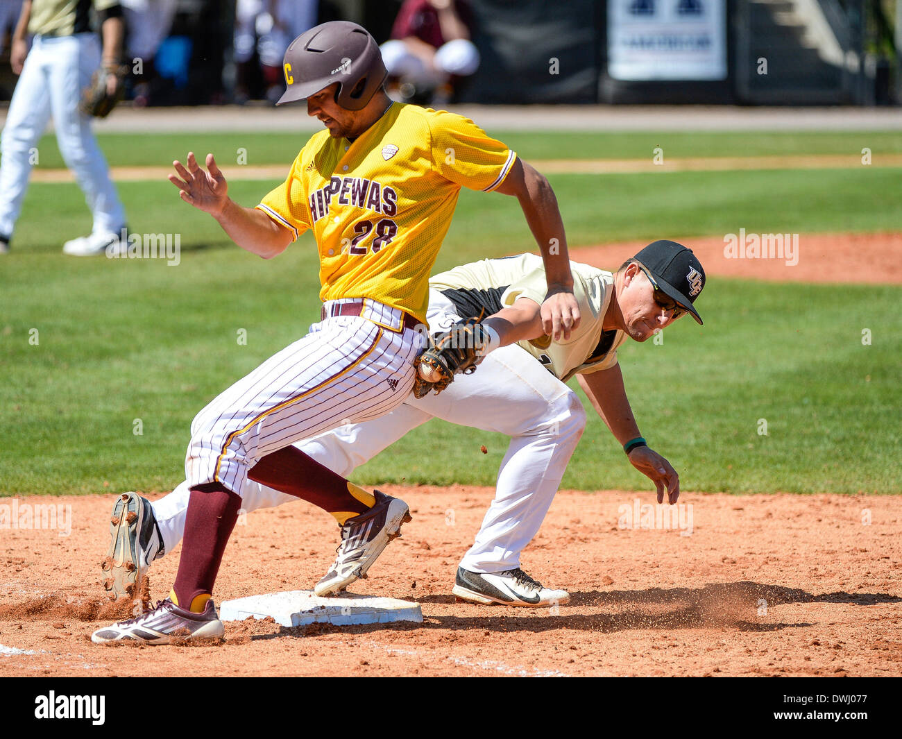 March 9, 2014 - Orlando, FL, U.S: Central Michigan outfielder Neal Jacobs (28) is safe from the tag of UCF first baseman James Vasquez (13) during NCAA baseball game 3 action between the Central Michigan Chippewas and the UCF Knights. UCF defeated CMU 5-4 at Jay Bergman Field in Orlando, FL Stock Photo