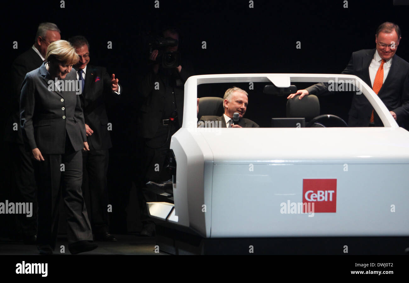 Hanover, Germany. 9th Mar, 2014. German Chancellor Angela Merkel (1st L) views a model of an Audi driverless car during the opening ceremony of the CeBIT tech fair in Hanover, Germany, March 9, 2014. German Chancellor Angela Merkel and British Prime Minister David Cameron jointly opened CeBIT, one of the world's largest IT fairs, in western German city of Hanover on Sunday. © Zhang Fan/Xinhua/Alamy Live News Stock Photo