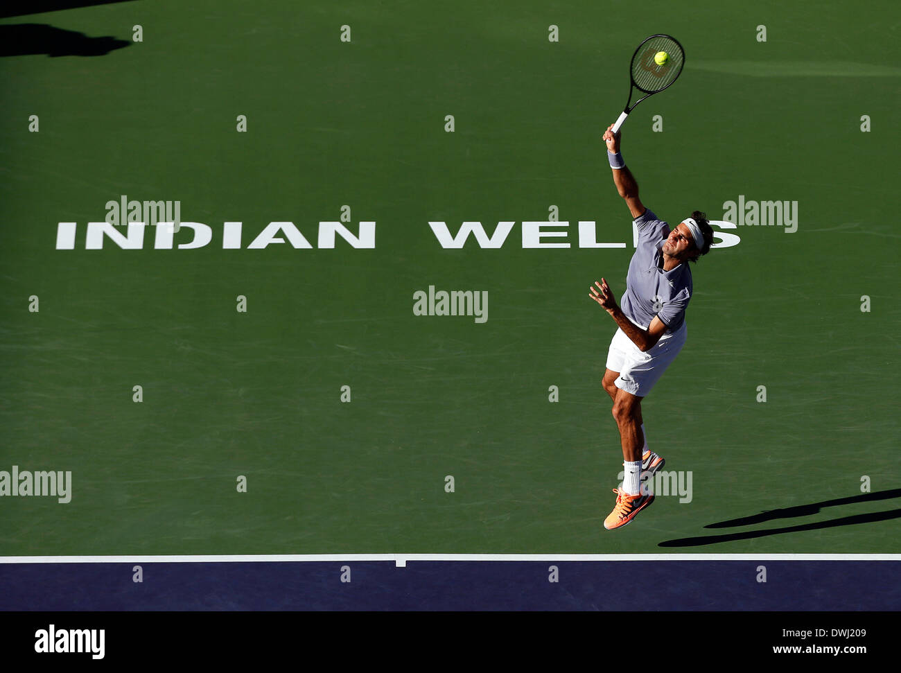 Indian Wells, California, USA. 08 March, 2014: Roger Federer of Switzerland serves to Paul-Henri Mathieu of France during the BNP Paribas Open at Indian Wells Tennis Garden in Indian Wells CA./Alamy Live News Stock Photo