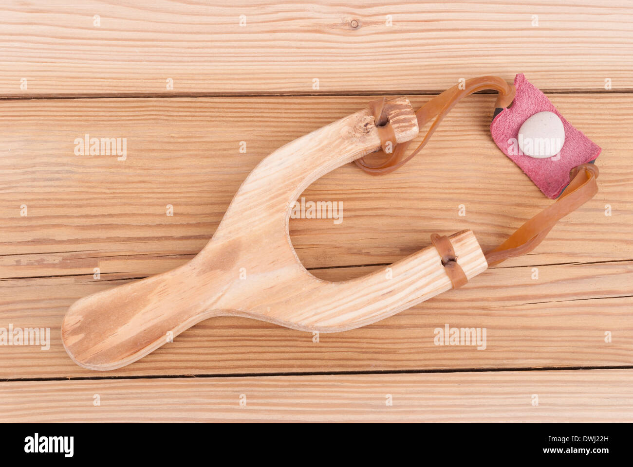 Slingshot on a wooden background. Stock Photo