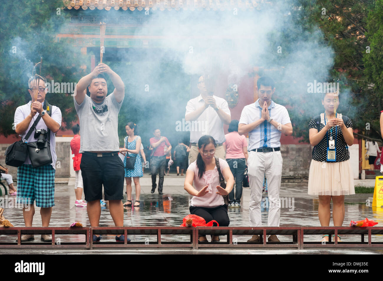 Buddhists burn incense and pray at Yonghegong Lama Temple in Beijing