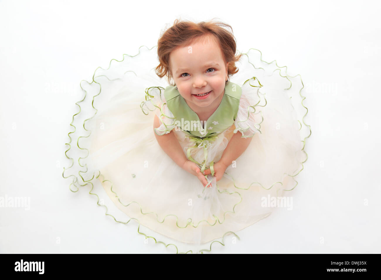 Beautiful girl wearing a festive dress, looking up Stock Photo