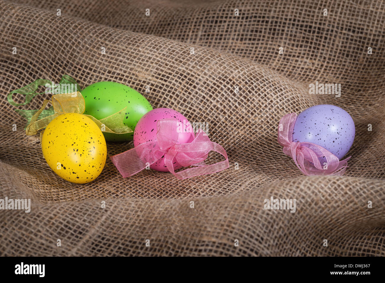 Colorful Easter eggs on burlap background Stock Photo
