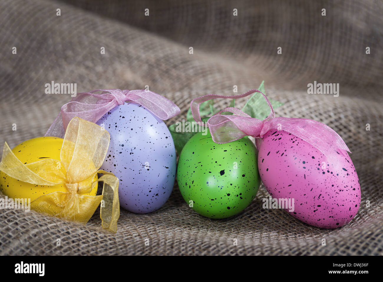 Colorful Easter eggs on burlap background Stock Photo