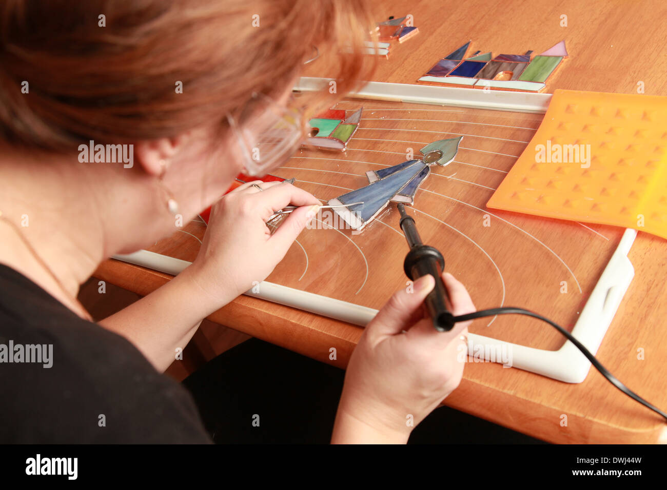 Stained glass maker works with small souvenirs Stock Photo Alamy
