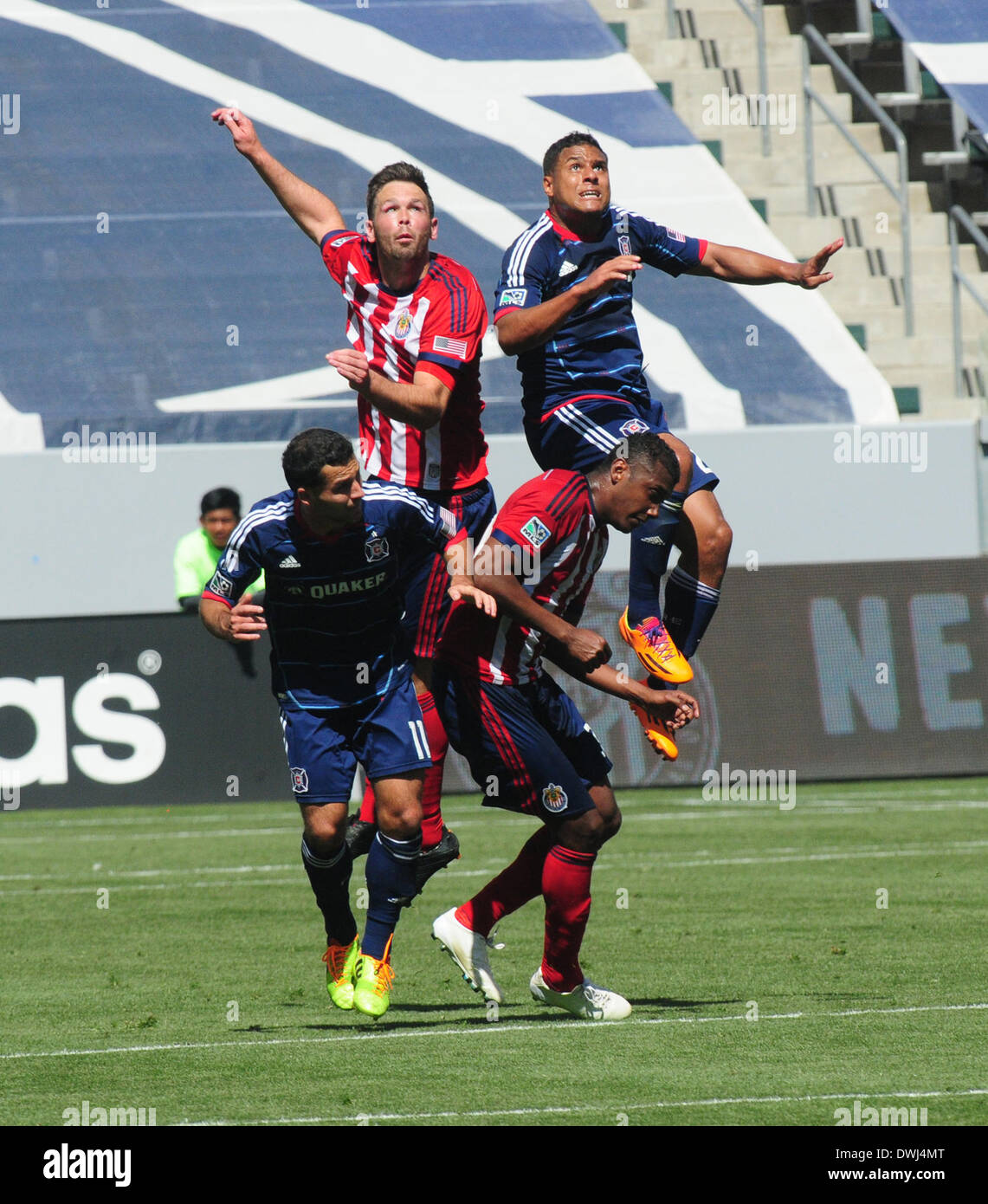 Carson, California, USA. 9th Mar, 2014. Major League Soccer-MLS- Chivas USA defenders OSWALDO MINDA and BOBBY BURLING (top left) fight Chicago Fire forward QUINCY AMARIKWA and mid fielder DILLY DUKA (bottom left) to control a head ball as Chivas USA went on to win the match 3 to 2 at the Stubhub Center, Carson, California, USA, March 9, 2013. This was the season opener for Chivas USA and the first win for their new coach.Credit Image cr Scott Mitchell/ZUMA Press © Scott Mitchell/ZUMAPRESS.com/Alamy Live News Stock Photo