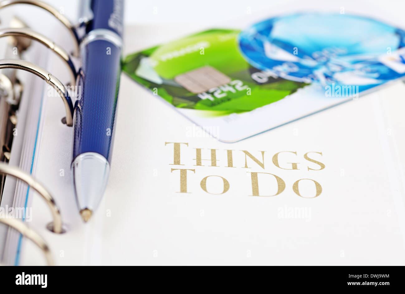 Credit card and the ball pen on the page of an organizer with the words "what to do" Stock Photo