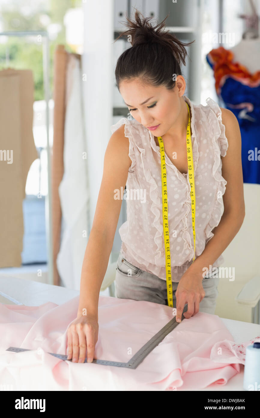Female fashion designer working on fabrics Stock Photo - Alamy