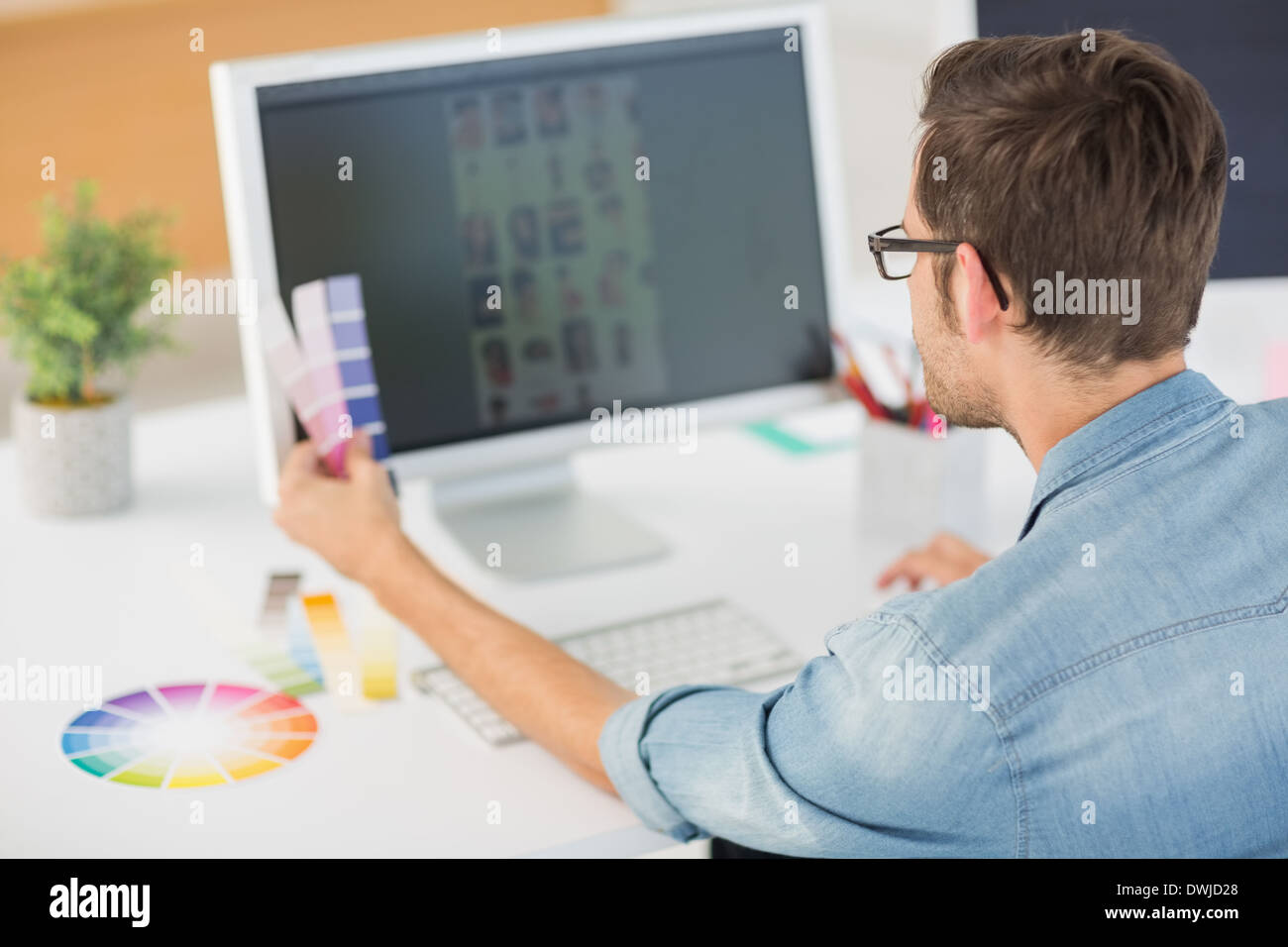 Casual male photo editor using computer Stock Photo