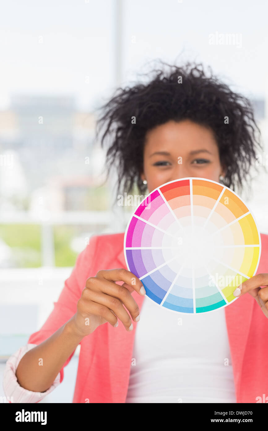 Beautiful young woman holding color wheel Stock Photo - Alamy