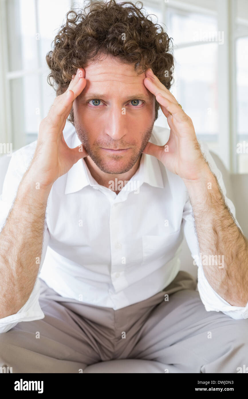 Worried well dressed man sitting with head in hands Stock Photo Alamy