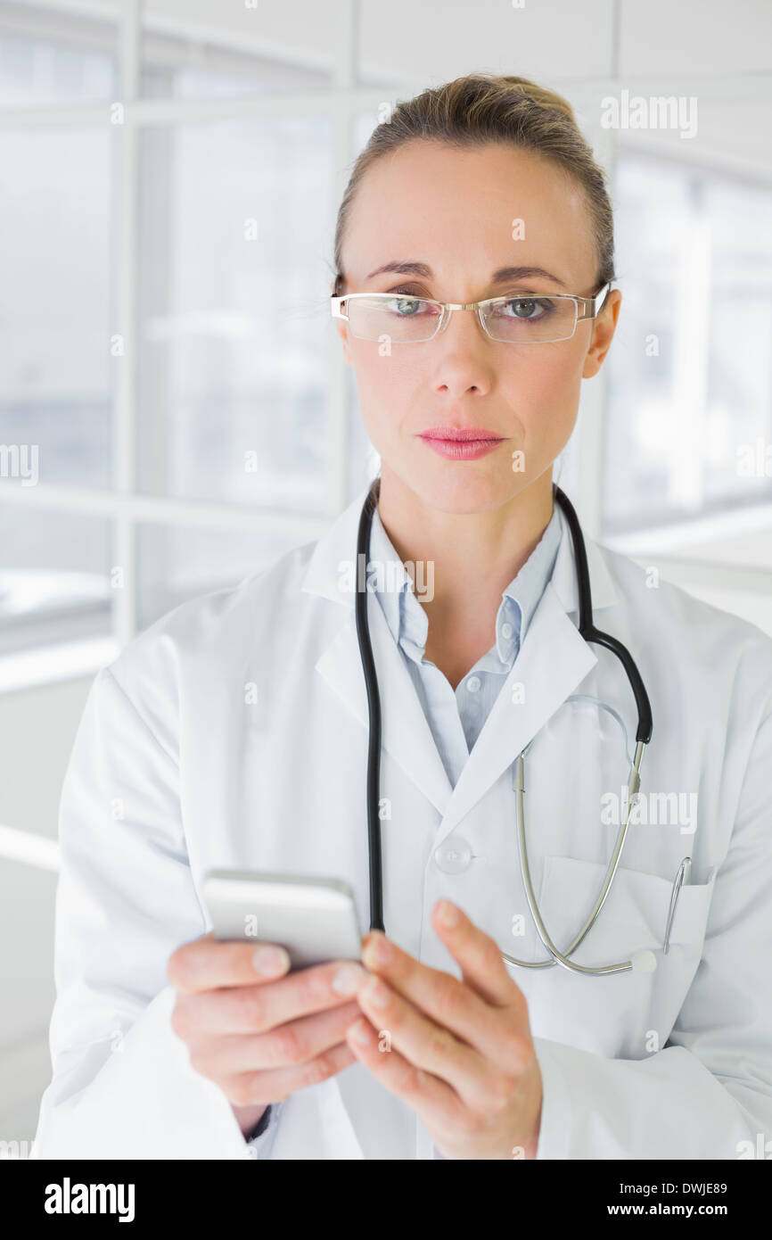 Portrait of a female doctor reading text message Stock Photo