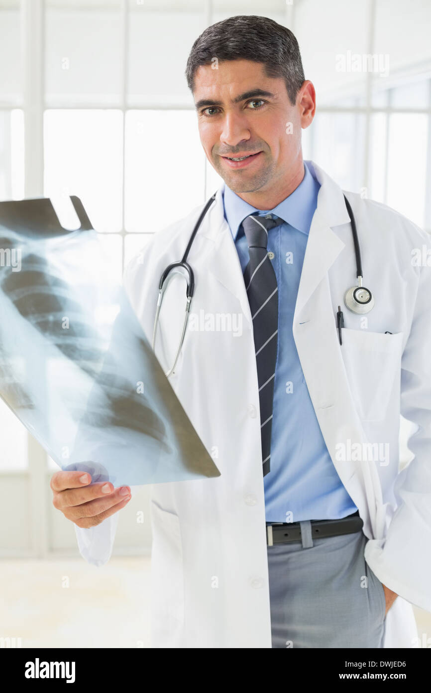 Portrait of a smiling male doctor holding xray Stock Photo - Alamy
